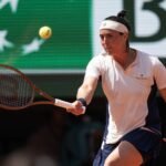 Ons Jabeur hits a forehand against Coco Gauff at the French Open.